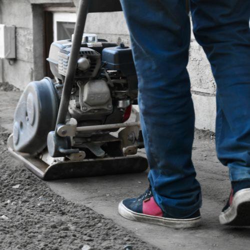 vibrating compactor plate on gravel driveway