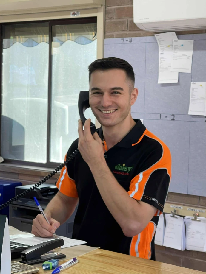 Daisys employee on the phone assisting a customer