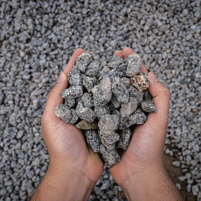 Hands displaying 20mm granite screenings